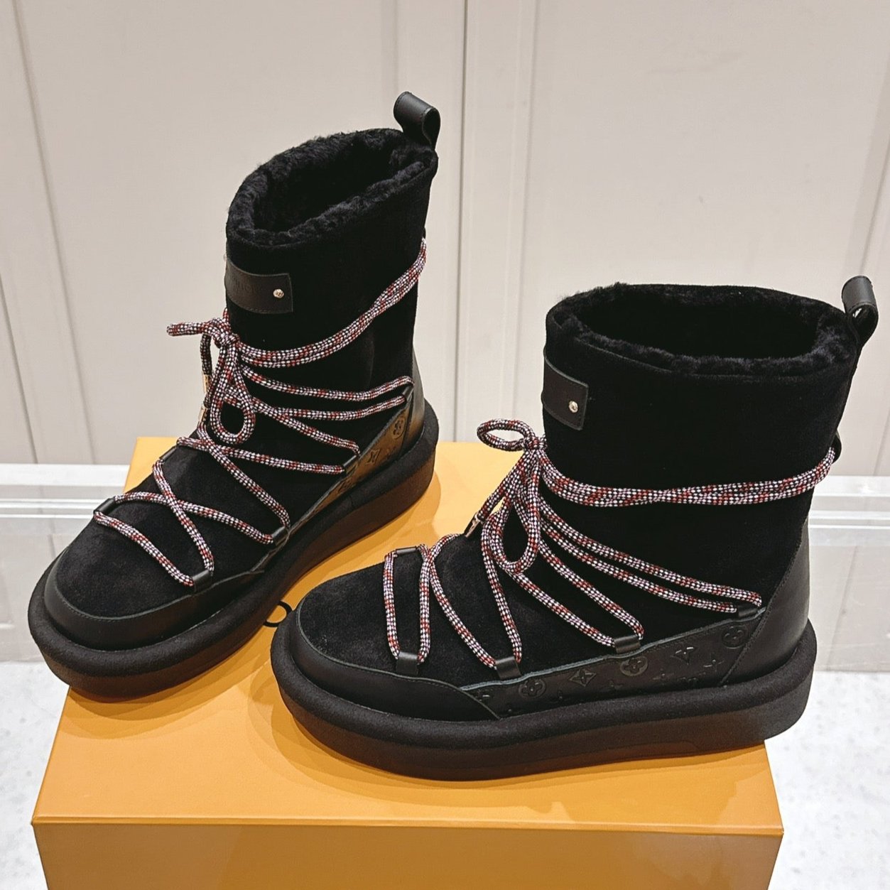 LOUIS VUITTON ASPEN PLATFORM ANKLE BOOT IN BLACK MONOGRAM DEBOSSED SUEDE AND SHEARLING