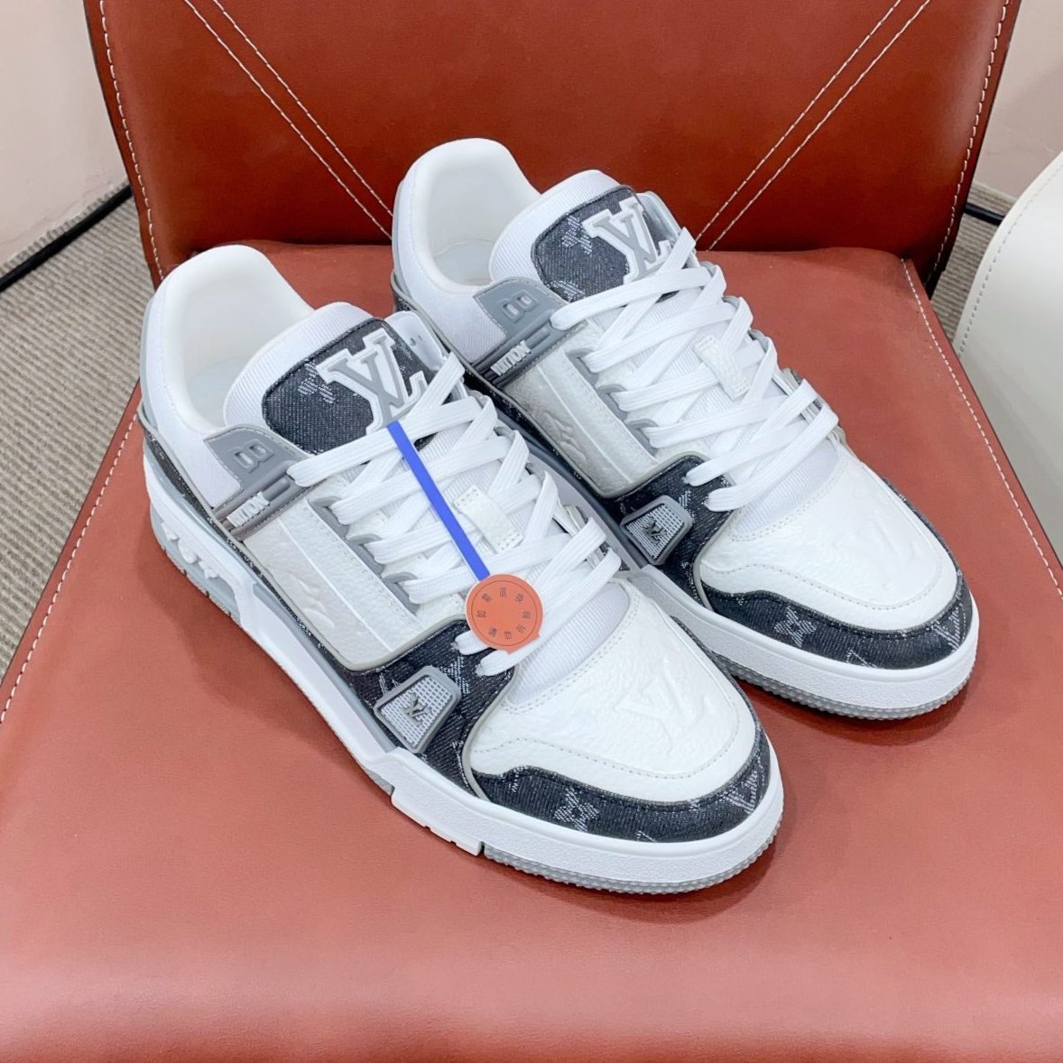 LOUIS VUITTON LV TRAINER SNEAKER IN WHITE CALFSKIN AND BLACK MONOGRAM DENIM