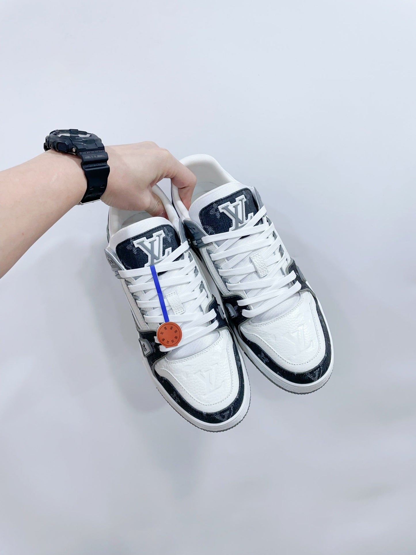 LOUIS VUITTON LV TRAINER SNEAKER IN WHITE CALFSKIN AND BLACK MONOGRAM DENIM